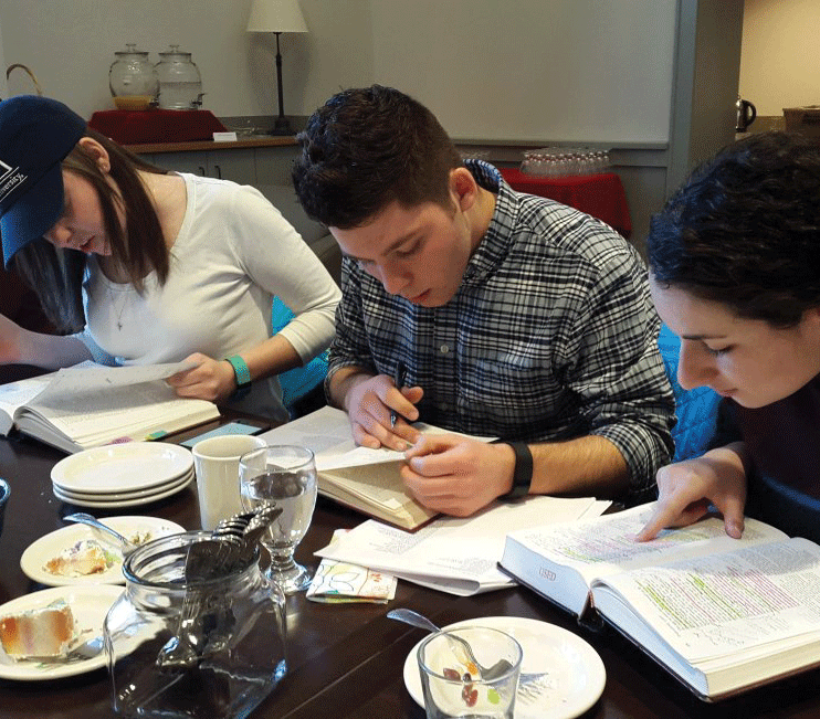 (from left to right) Sophomores Megan Leo, Matthew Leo and Jessica Blau partake in some Milton reading.