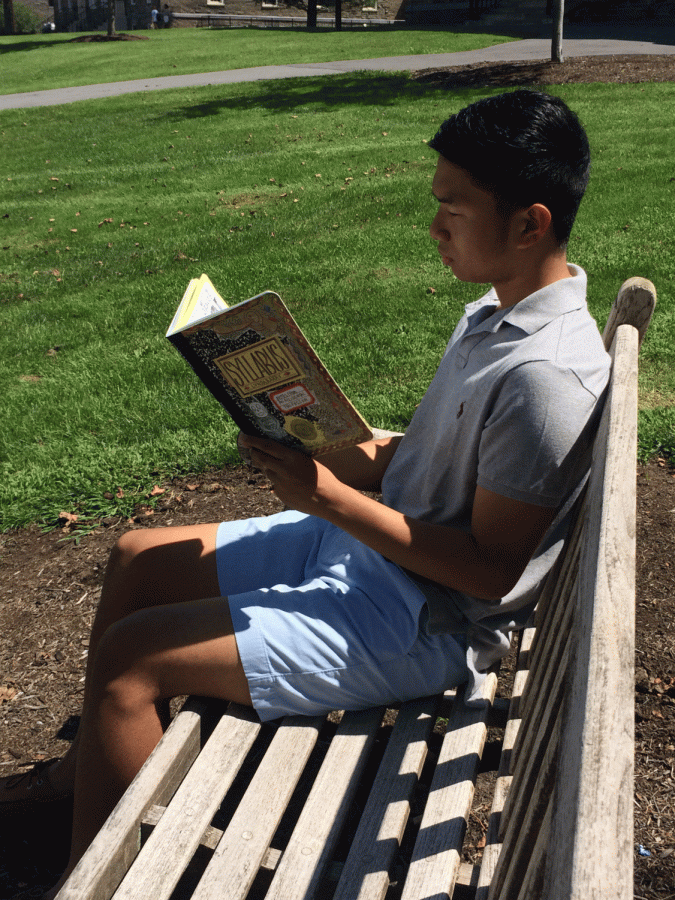 First-year John Bermudez catches up on summer reading before classes start on August 25. The required reading this year was Syllabus: Notes from an Accidental Professor by Lynda Barry.