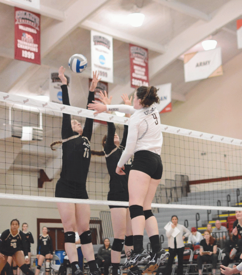 Senior outside hitter Kathleen Harris goes up for a spike, while Army struggles to block. Harris totaled 13 kills in the matchup. 