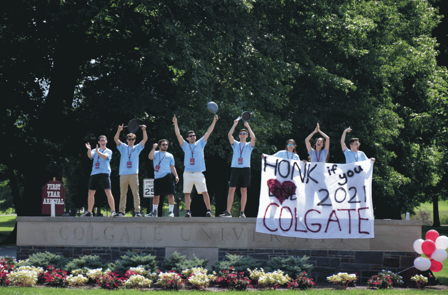 Link staff stands on the Colgate sign to welcome the  Class of 2021 to campus. This class has the strongest incoming academic profile of any class at Colgate.