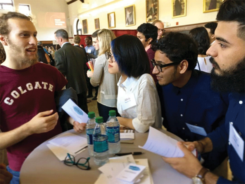 Colgate students try out a table card game created by alumna Taylor Buonocore Guthrie ’08. This game is meant to facilitate genuine connections. 
