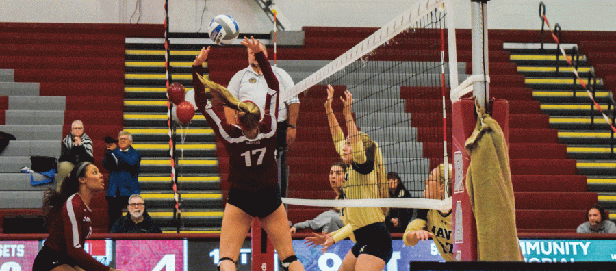 First-year outside hitter Julia Kurowski sets up a potential spike for junior middle blocker Jessica Lathan.