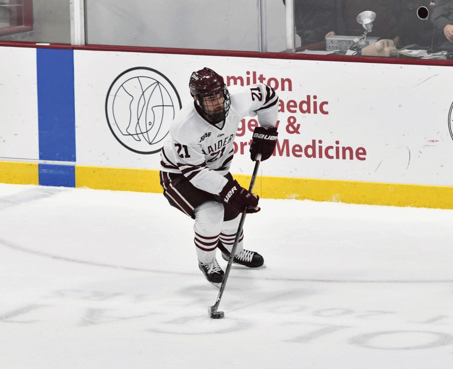 Junior forward Tyler Penner controls the puck to set up the offense for an attack. Penner scored a goal against the Niagara over this past weekend for his second of the season.