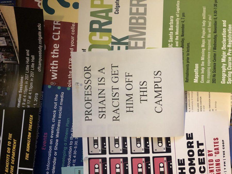 A flyer put up in the COOP that reads, PROFESSOR SHAIN IS A RACIST GET HIM OFF THIS CAMPUS. These posters were also found in McGregory Hall and Alumni Hall.