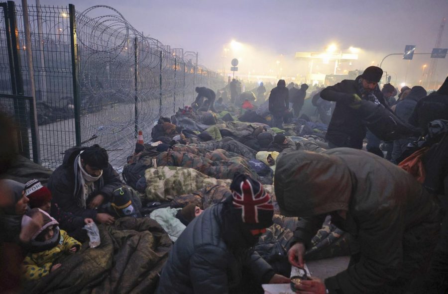 CRISIS AT THE BORDER: Migrants huddle for warmth at the Kuznitsa checkpoint at the Poland-Belarus border on Nov. 15.