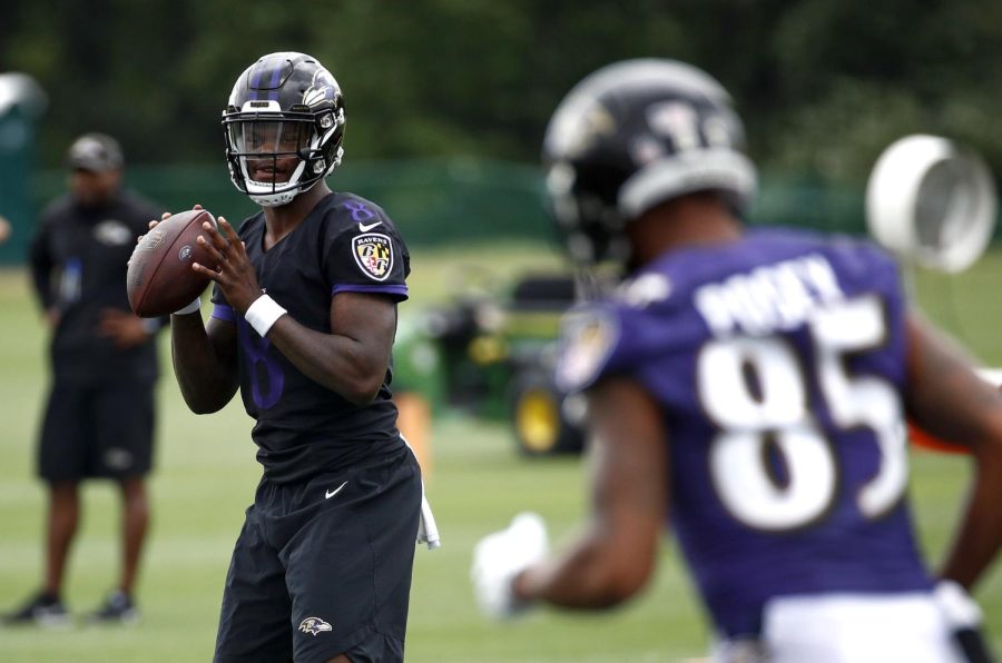 Baltimore Ravens quarterback Lamar Jackson, left, runs a drill during an NFL football training camp practice at the teams headquarters, Monday, July 23, 2018, in Owings Mills, Md. (AP Photo/Patrick Semansky)