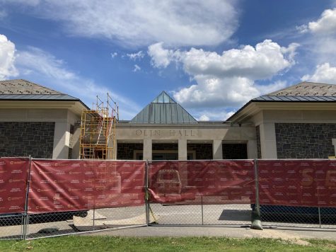 Renovation equipment and a chain link fence obscures the main entrance to Olin Hall. Construction on the building will last until Aug. 2023.
