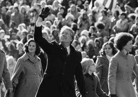 President Carter waves to crowds along Pennsylvania Avenue following his Inauguration in 1977