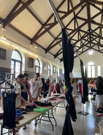 SUSTAINABLE STYLE: Colgate students browse through Hami-Down Gates stock of secondhand clothes in the Hall of Presidents in James C. Colgate Hall.